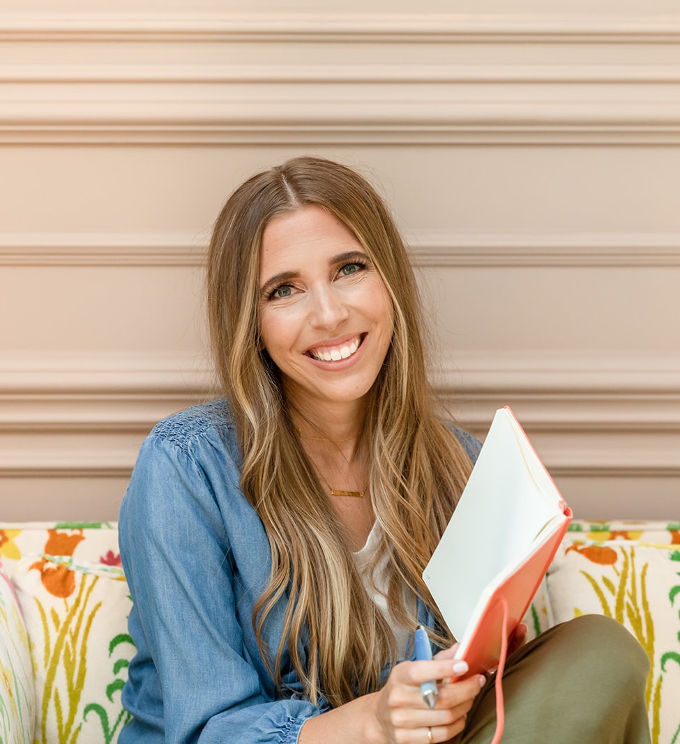 shana sitting on couch with notebook of connection ideas
